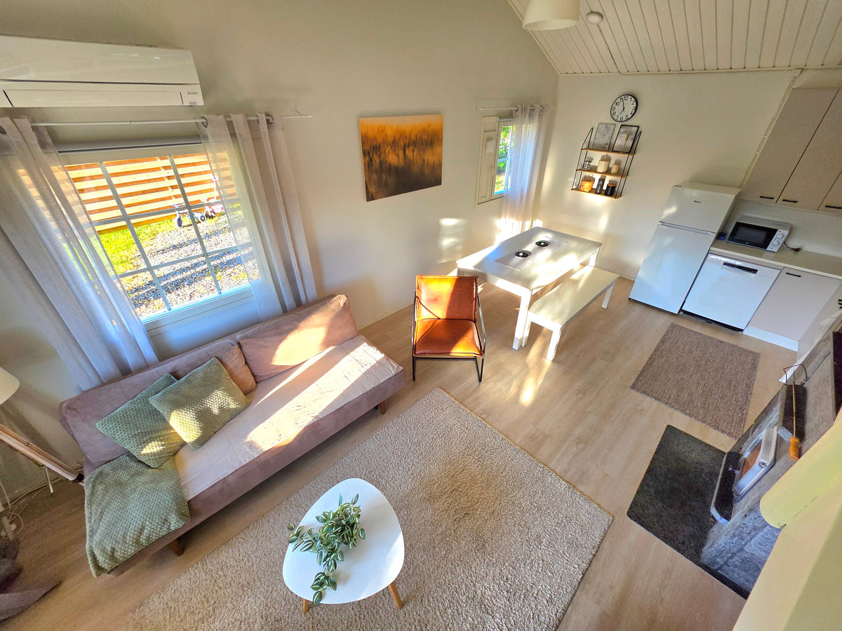 Bright and modern living room wih open-plan kitchen at Villa in Ranua, Finnish Lapland